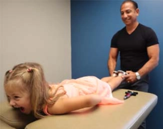 Chiropractor Milford CT Franco Menta Adjusting Pediatric Patient