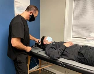 Chiropractor Milford CT Franco Menta Examining Patient